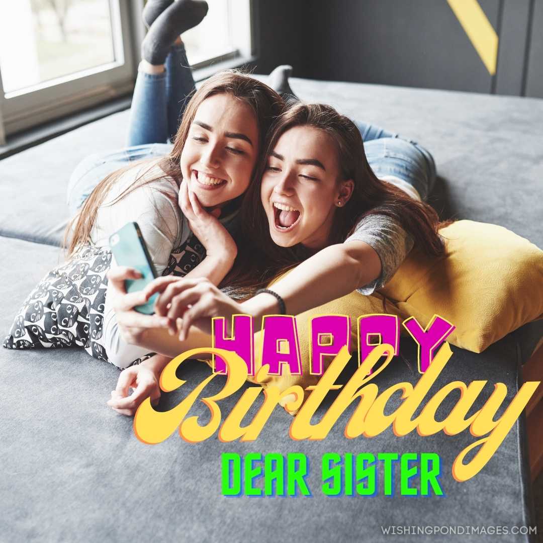 Caring sister with two little sisters smiling and looking at the camera while holding black collagen